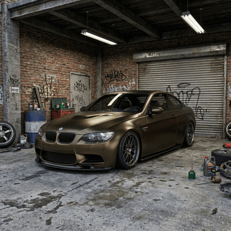 A matte bronze BMW sports car, wrapped in Satin Gold Green SelfRepair Nano-Coated PPF, sits in a gritty urban garage with graffiti, scattered tools and tires. Overhead lights enhance its luxurious finish and unique satin gold green look.