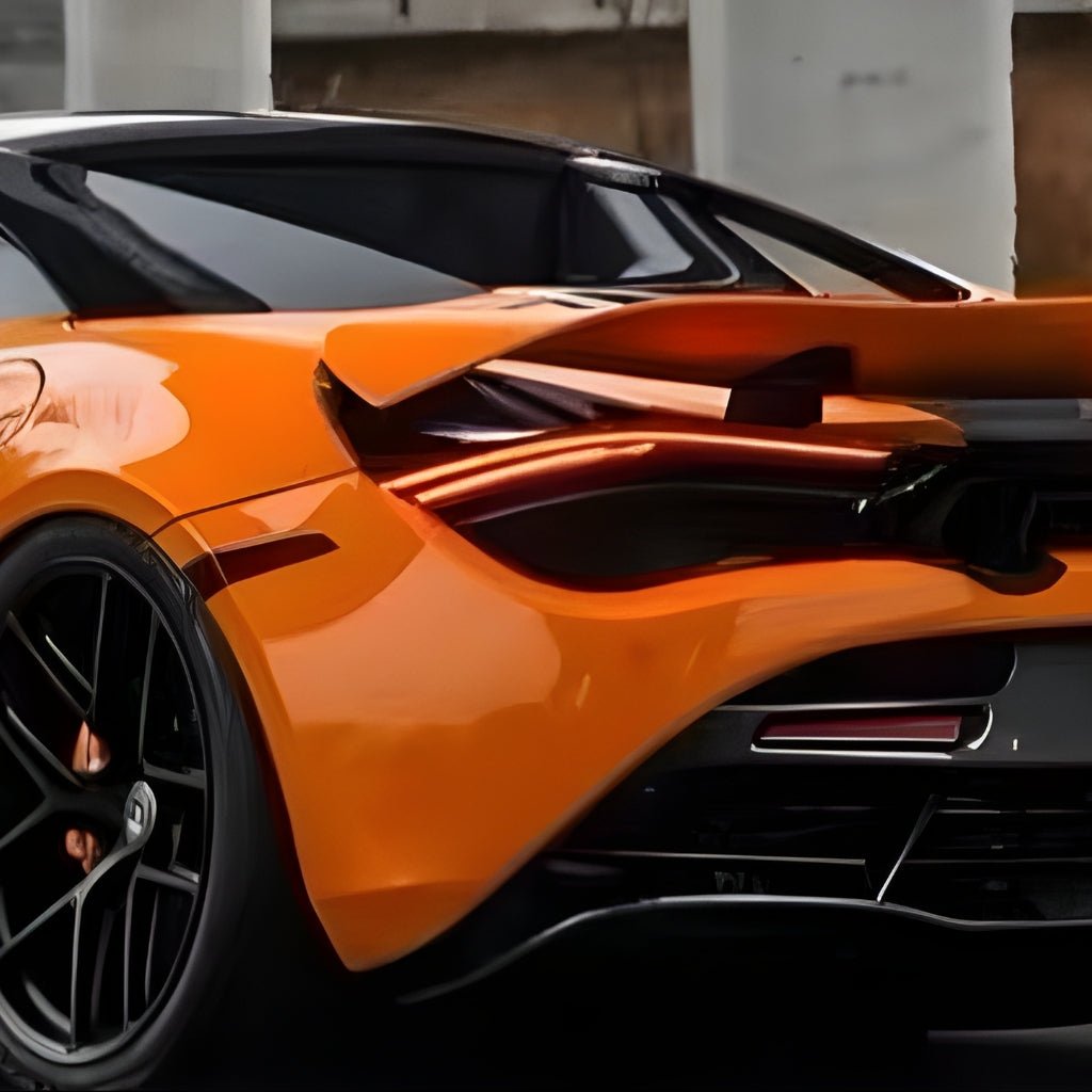 Close-up of a McLaren Orange Glossy sports car’s rear, featuring sleek curves, black alloy wheel, rear spoiler, and LED tail lights protected by McLaren Orange Glossy SelfRepair Nano-Coated PPF.