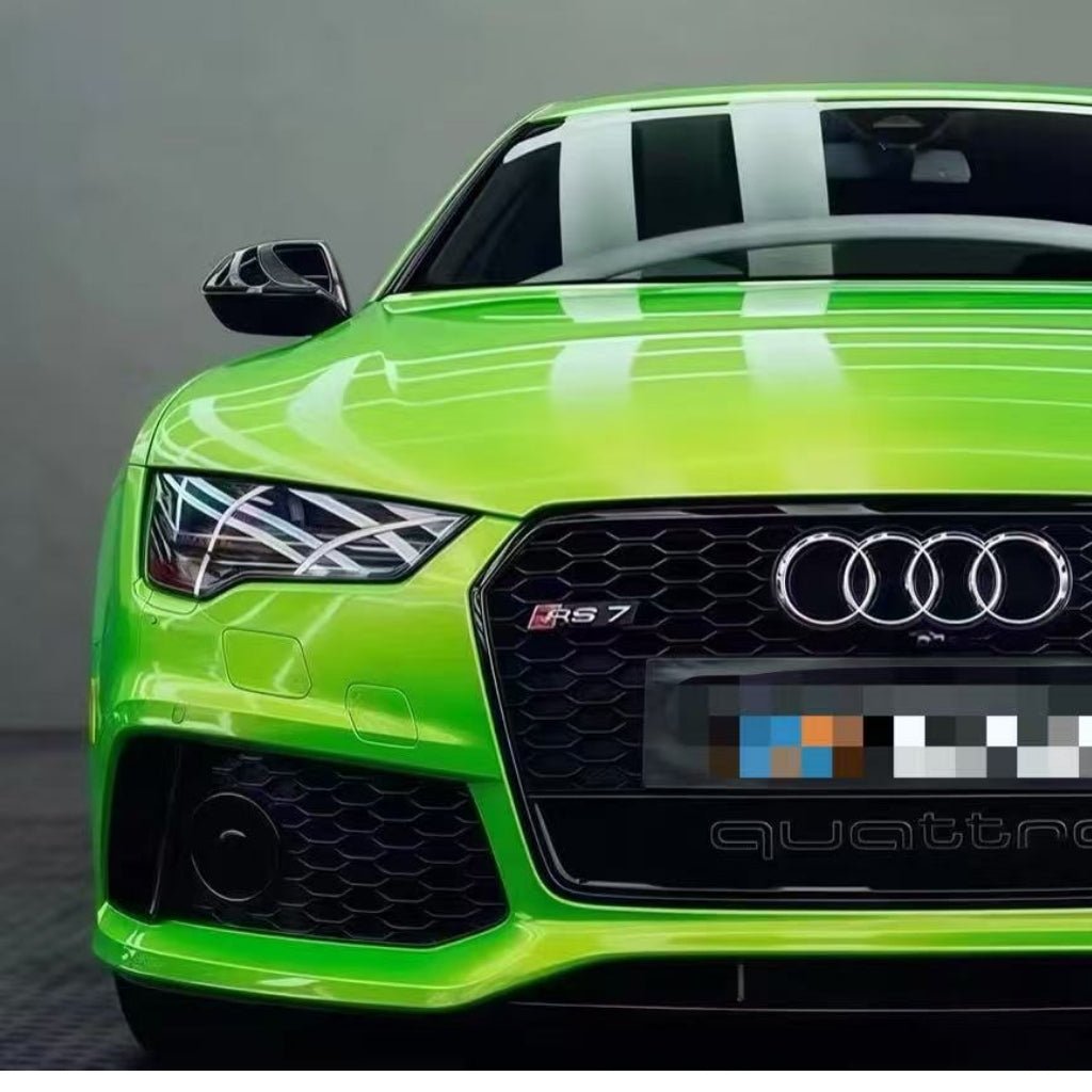 Front view of an Audi RS7 in Gold Green Charm SelfRepair Nano-Coated PPF, featuring a black grille, quattro badge, and LED headlights. The luxusná farba reflects indoor lighting as the car is parked indoors.