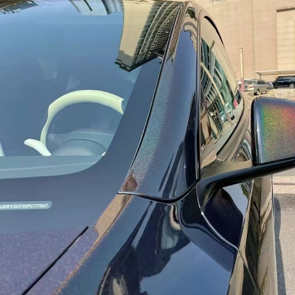Close-up of a dark car with Black Galaxy Glossy SelfRepair Nano-Coated PPF, highlighting the driver’s side mirror and window. Buildings and blue sky reflect on its surface, showcasing elegant ochrana karosérie.