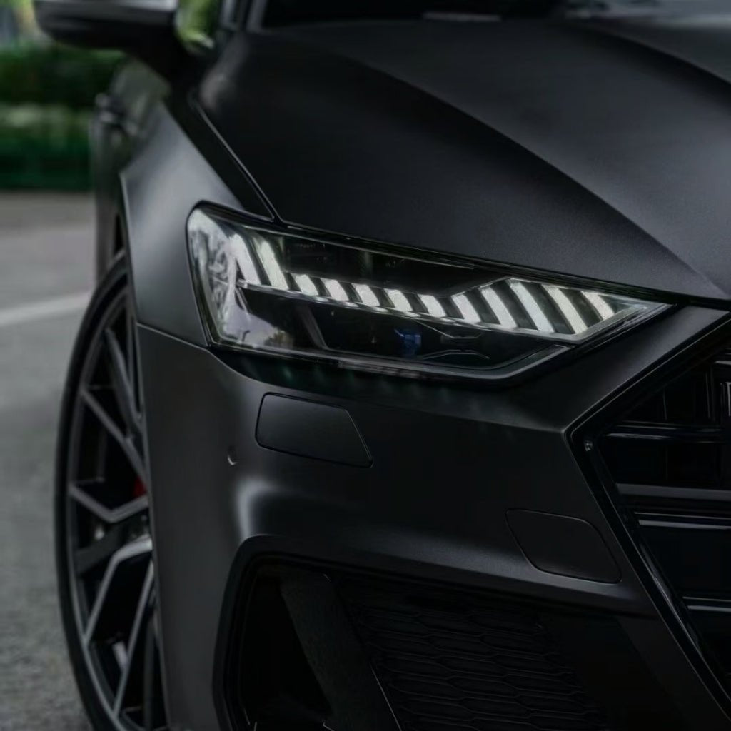 Close-up of the front left headlight and grille of a sleek black car with sharp lines, LED lights, and Phantom Black Matte SelfRepair Nano-Coated PPF, highlighting its sporty and luxurious design.