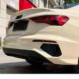 The image shows the rear view of a beige Audi sedan with Khaki Milan Glossy SelfRepair Nano-Coated PPF, highlighting its ochrana karosérie, Audi logo, and taillights as it’s parked on a paved area near a building.