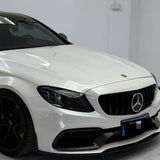 A white Mercedes-Benz parked indoors showcases the Arctic White Sparkle Glossy SelfRepair Nano-Coated PPF for ochrana karosérie. The front grille, Mercedes emblem, headlights, and part of a black wheel stand out against a clean white background.