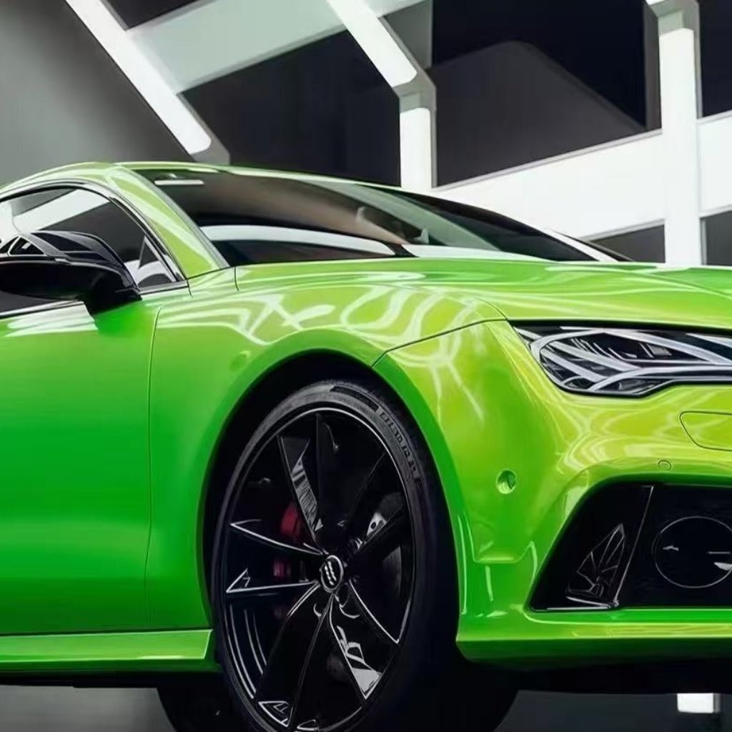 A Gold Green Charm SelfRepair Nano-Coated PPF sports car with a sleek, modern design sits indoors under geometric white lights, its vibrant finish and black alloy wheels gleaming while the PPF protects its glossy surface.