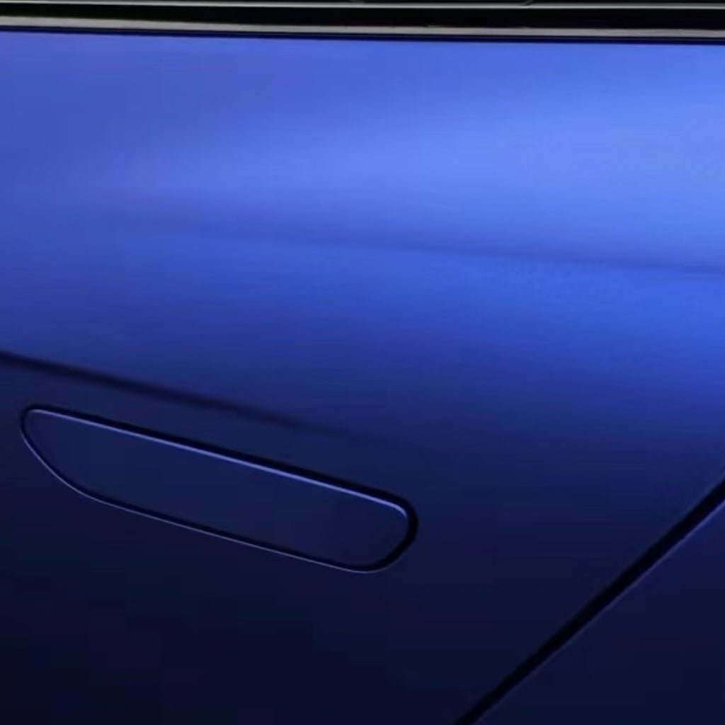 Close-up of a blue car door wrapped in Diamond Blue Matte SelfRepair Nano-Coated PPF, featuring a flush handle and window above. Sleek lines and smooth, reflective paint are protected by this advanced ochranná fólia na auto.