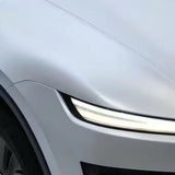 Close-up of the front left side of a sleek silver car, featuring a modern LED headlight and curved hood enhanced with Transparent Sparkle Matte SelfRepair Nano-Coated PPF for superior paint protection.