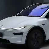 A sleek white electric car with black rims and tinted windows is parked indoors, featuring a smooth, modern design and protected by Transparent Sparkle Matte SelfRepair Nano-Coated PPF for a flawless matte finish.