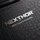 Close-up of the black, textured leather surface from the Nexthor PPF Sample Kit (All Colors) featuring a metallic NEXTHOR™ logo above “NEXT GENERATION PPF” in white text.